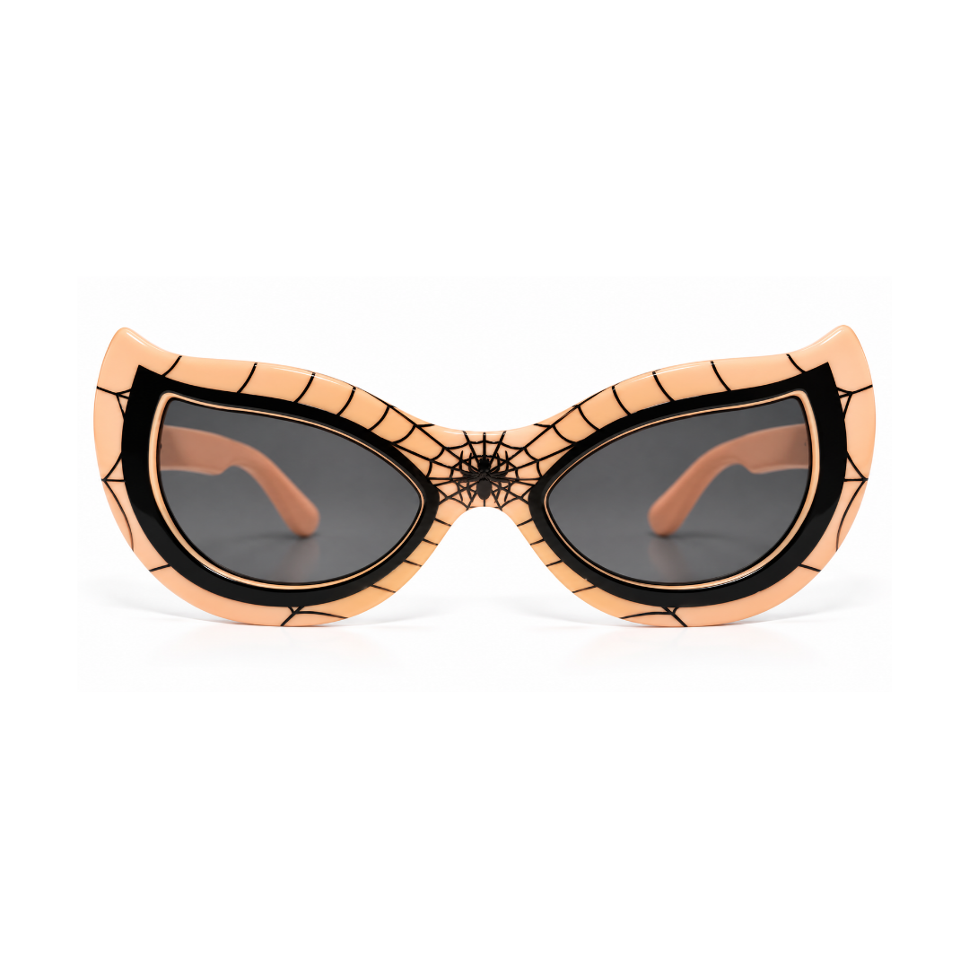 Spider-themed cat-eye sunglasses with a peach-colored frame featuring black web patterns and a spiderweb design at the bridge, paired with dark lenses.