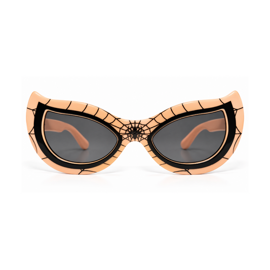 Spider-themed cat-eye sunglasses with a peach-colored frame featuring black web patterns and a spiderweb design at the bridge, paired with dark lenses.